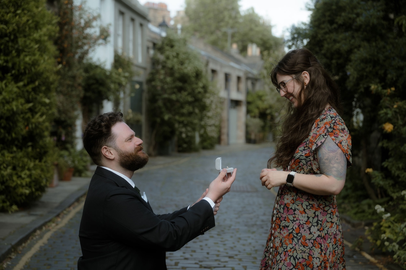 Joyful reaction of a girl getting proposed to by her boyfriend in Edinburgh New Town
