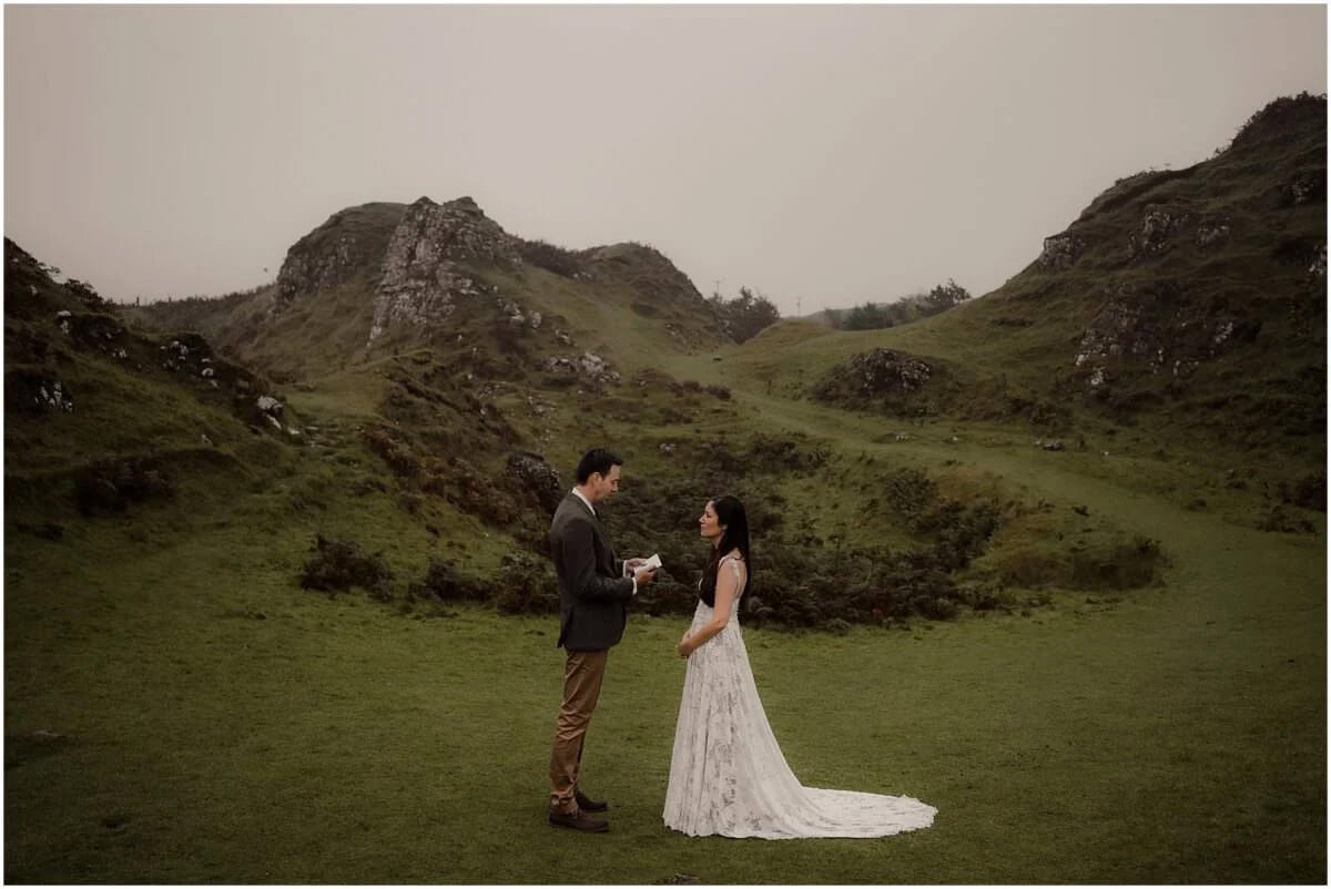 Tim reading his vows to Rebecca in Fairy Glen, with the rocky peaks of Isle of Skye rising behind them