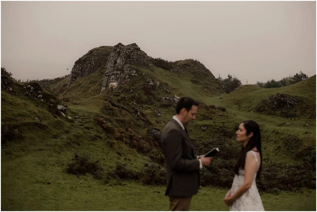  Rebecca and Tim exchanging vows in Fairy Glen while a sheep watches from the hillside above