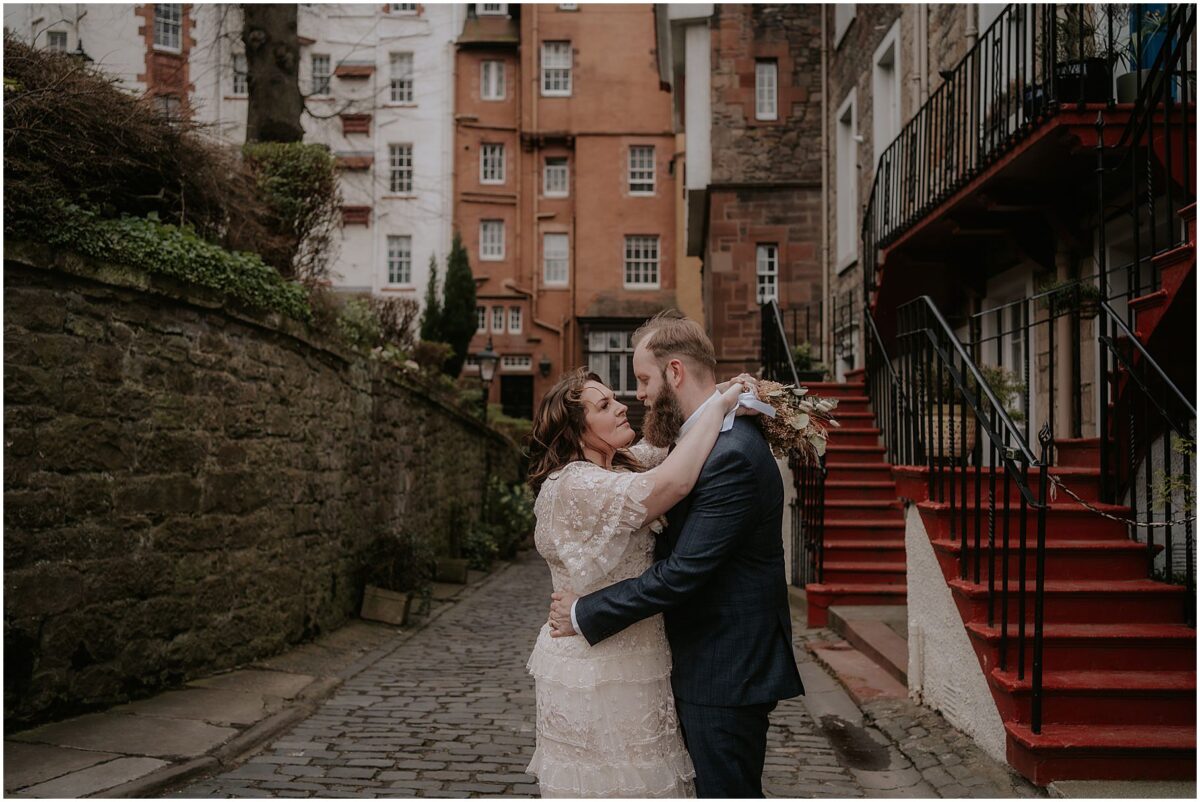 Newlywed sharing a hug at Ramsay Lane in Edinburgh