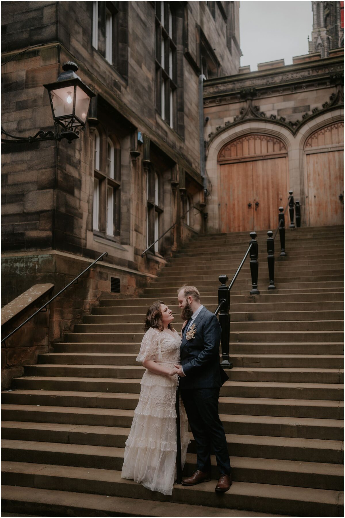 Bride and groom holding hands at the bottom of the Assembly Rooms