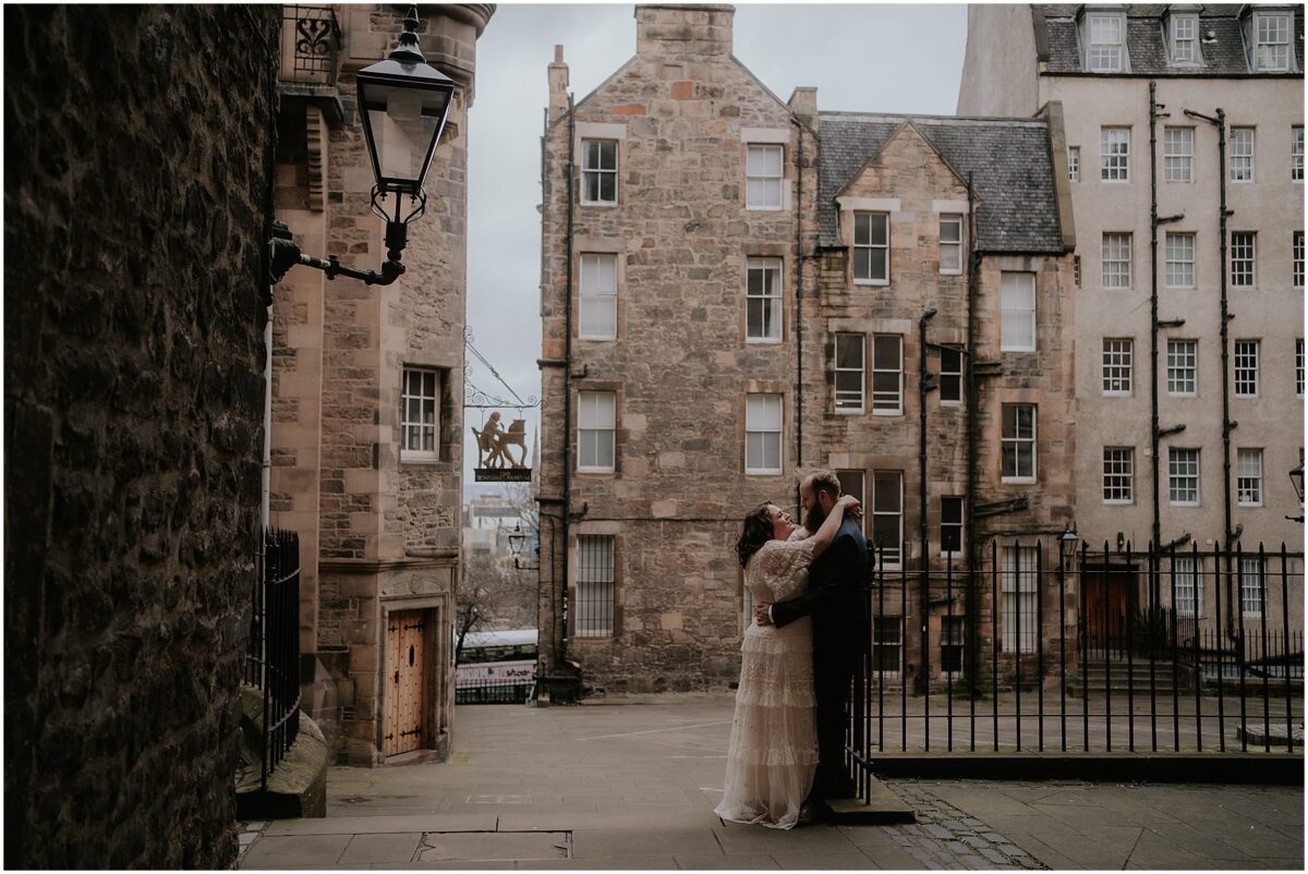 Bride and groom embracing at Lady Stair's Close courtyard in Edinburgh city centre