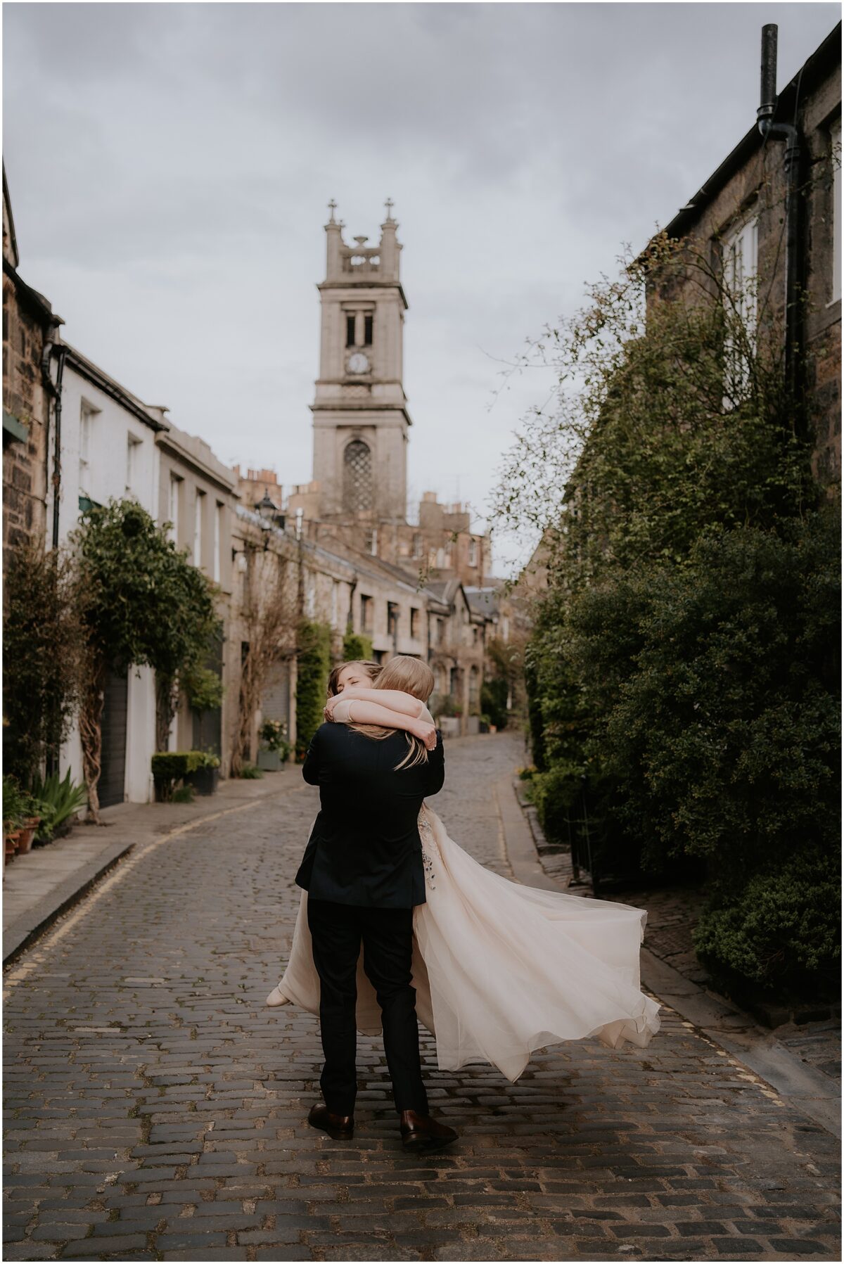 Groom twirling his bride joyfully in Stockbridge area of the city