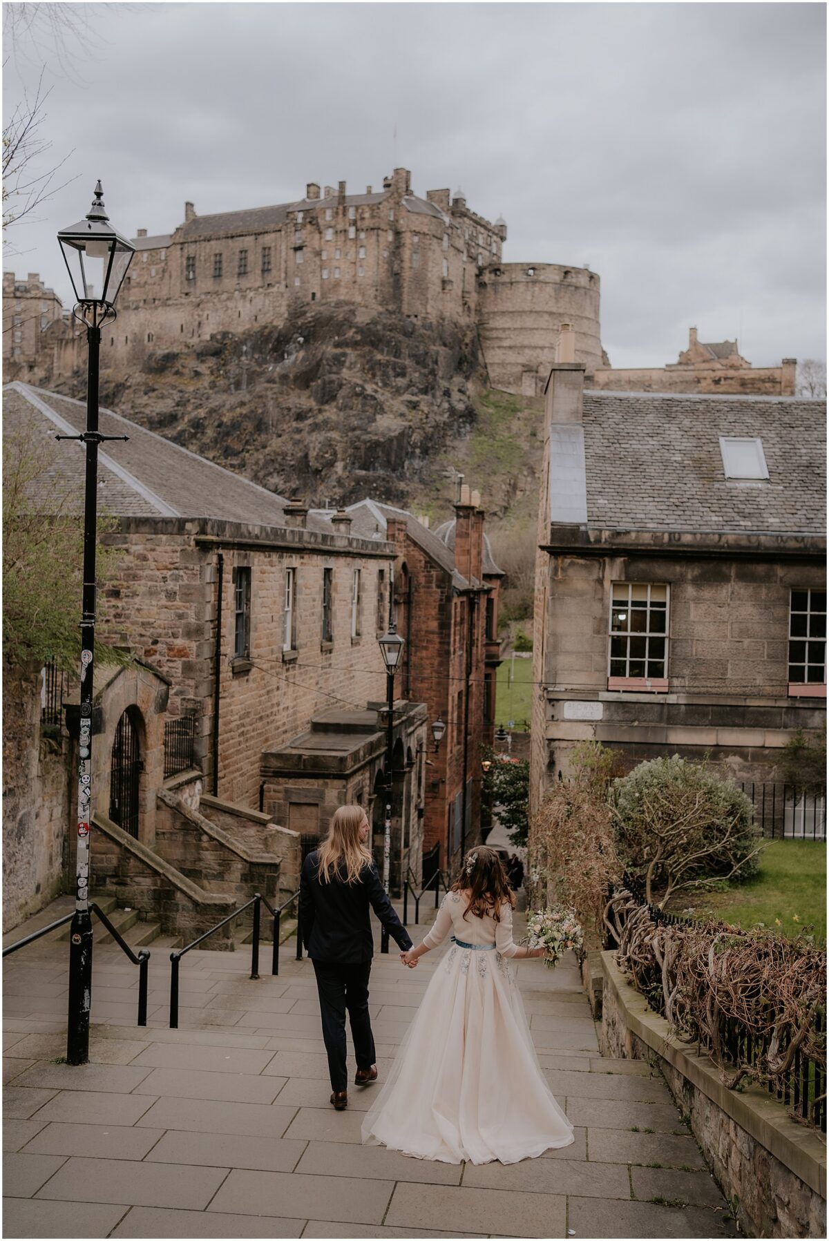 Newlyweds walking down the Old Town steps towards the Grassmarket