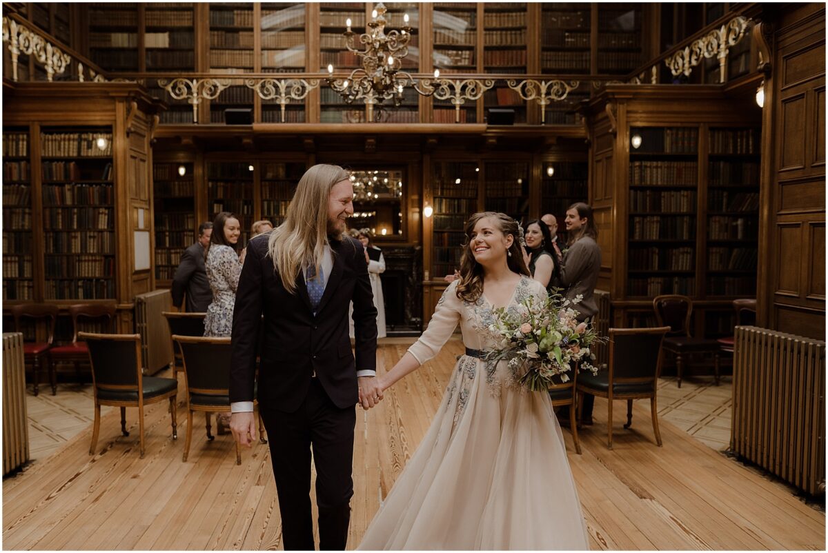 New bride and groom exchanging a loving glance at the end of the aisle