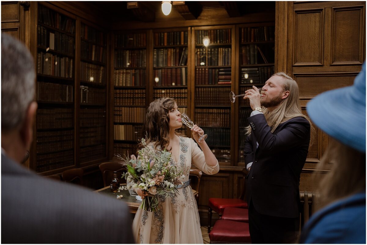 Married couple during a toast - each taking a sip of champagne