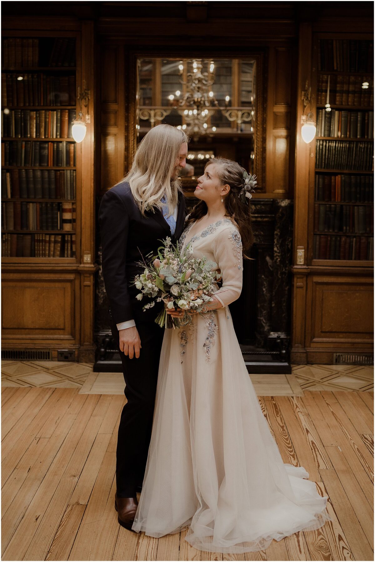 Official wedding portraits of the wedding couple in an embrace, sharing a glance