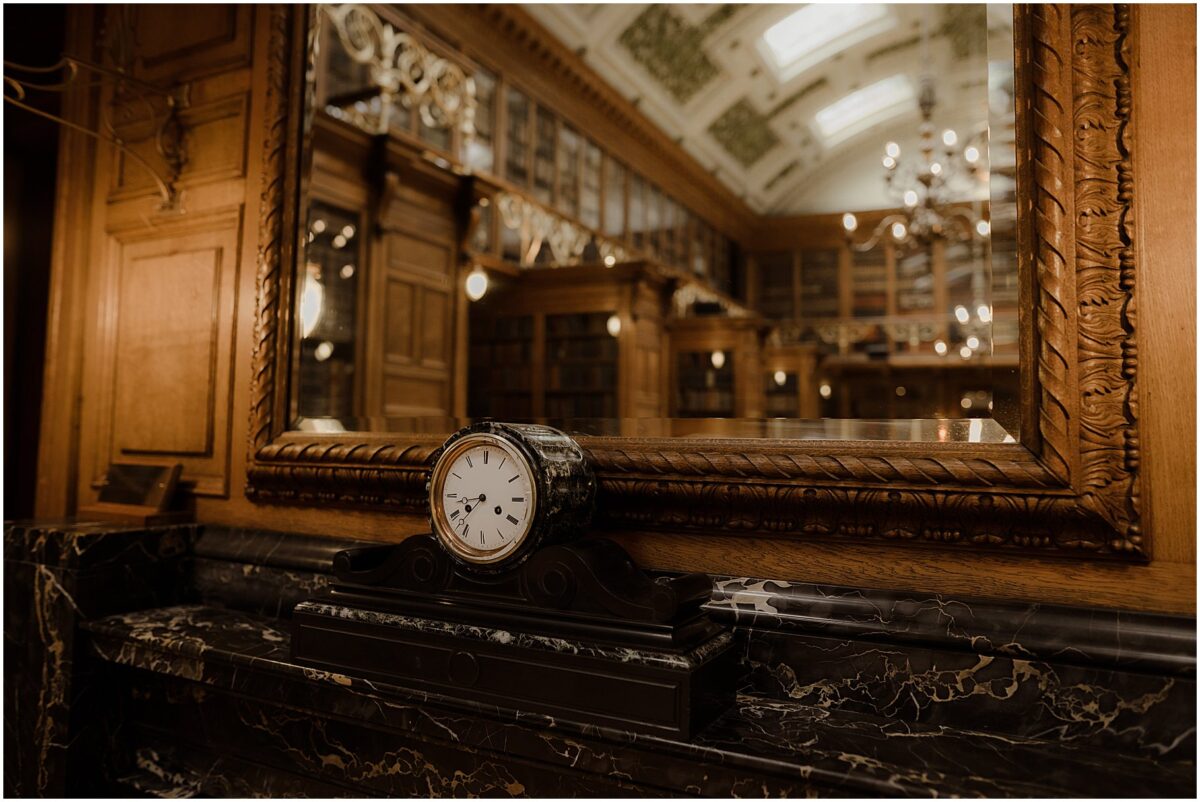 Old clock sitting on a black marble fireplace