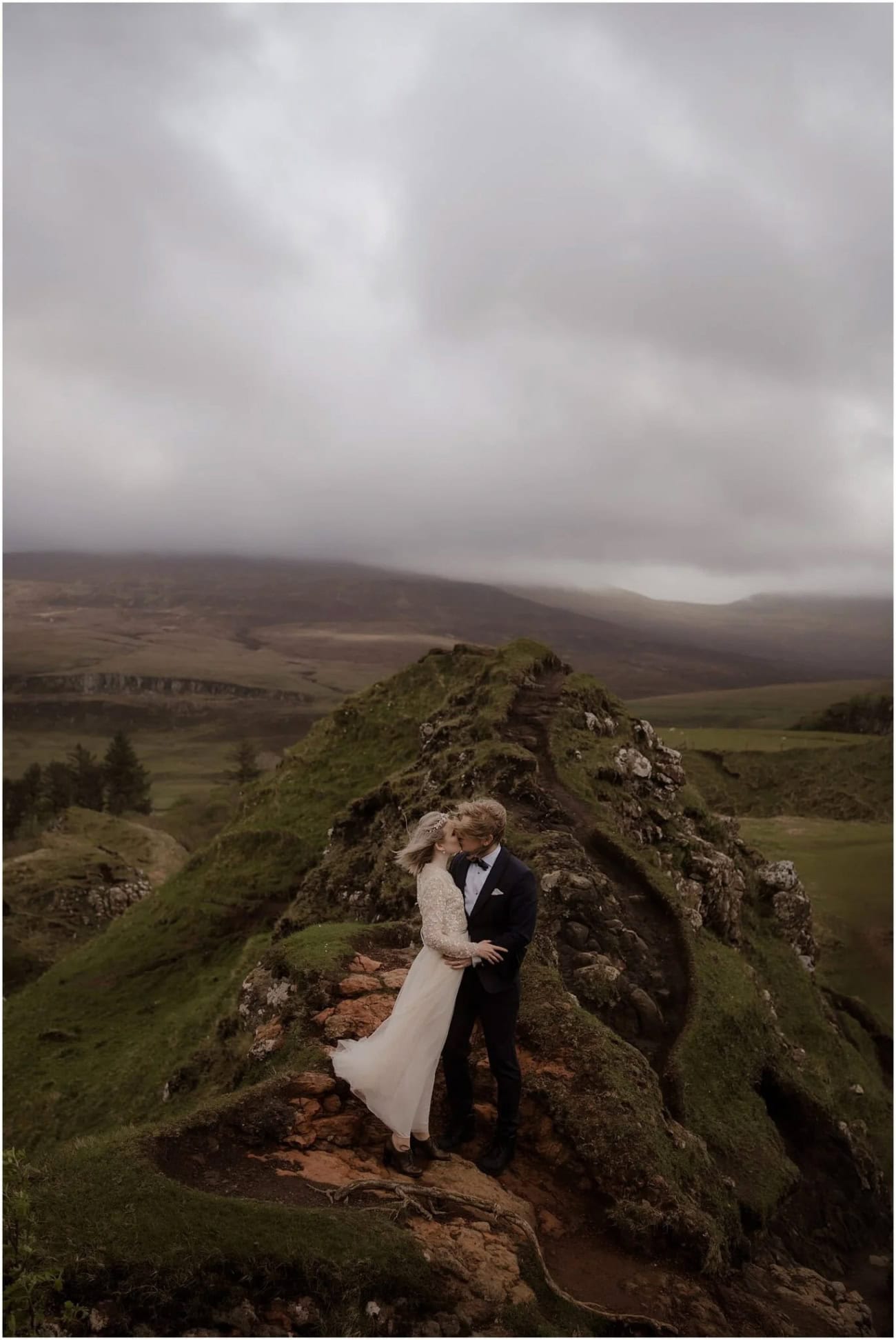 Isle of Skye elopement in Fairy Glen - Isle of Skye wedding photographer Couple sharing a kiss on the mossy rocky ridge at Fairy Glen