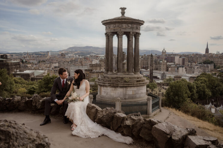 Bride and groom holding hands on Calton Hill - Edinburgh wedding photographer