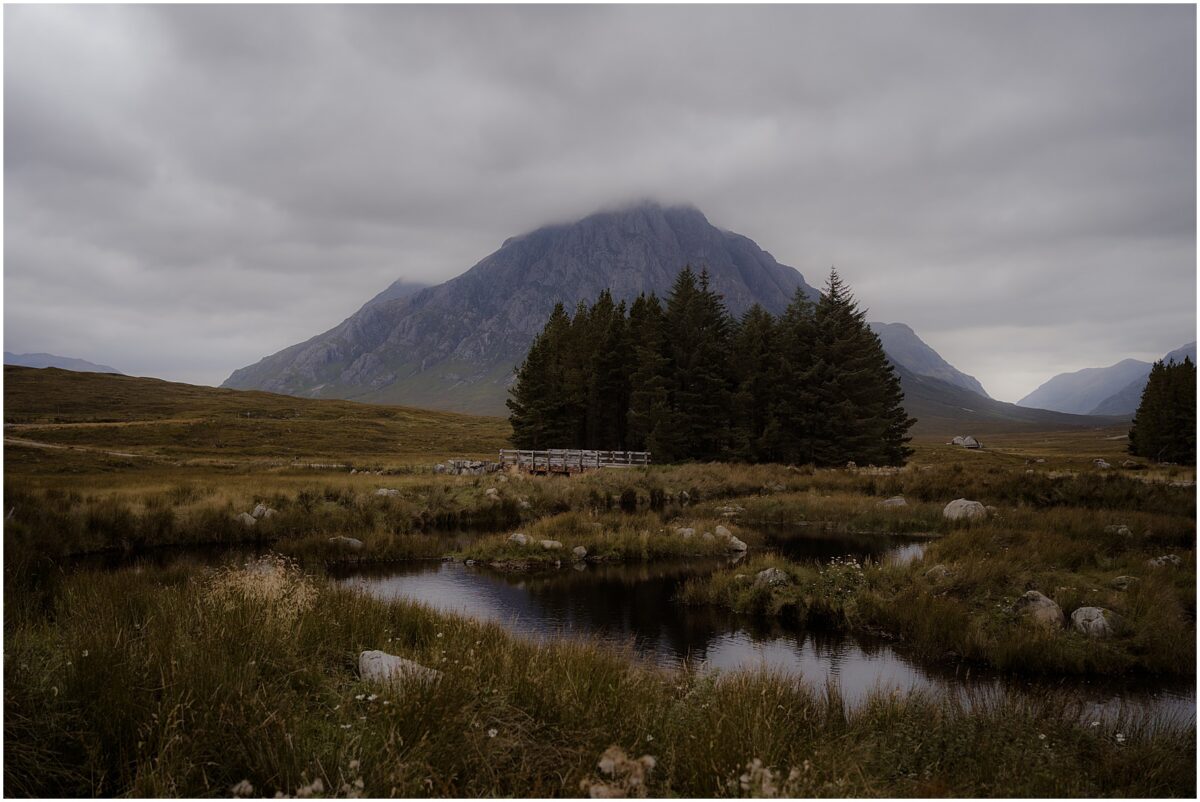 Glencoe wedding photos - Glencoe wedding photographer Buachaille Etive Mòr reflected in dawn-still pond beside Kingshouse Hotel boardwalk