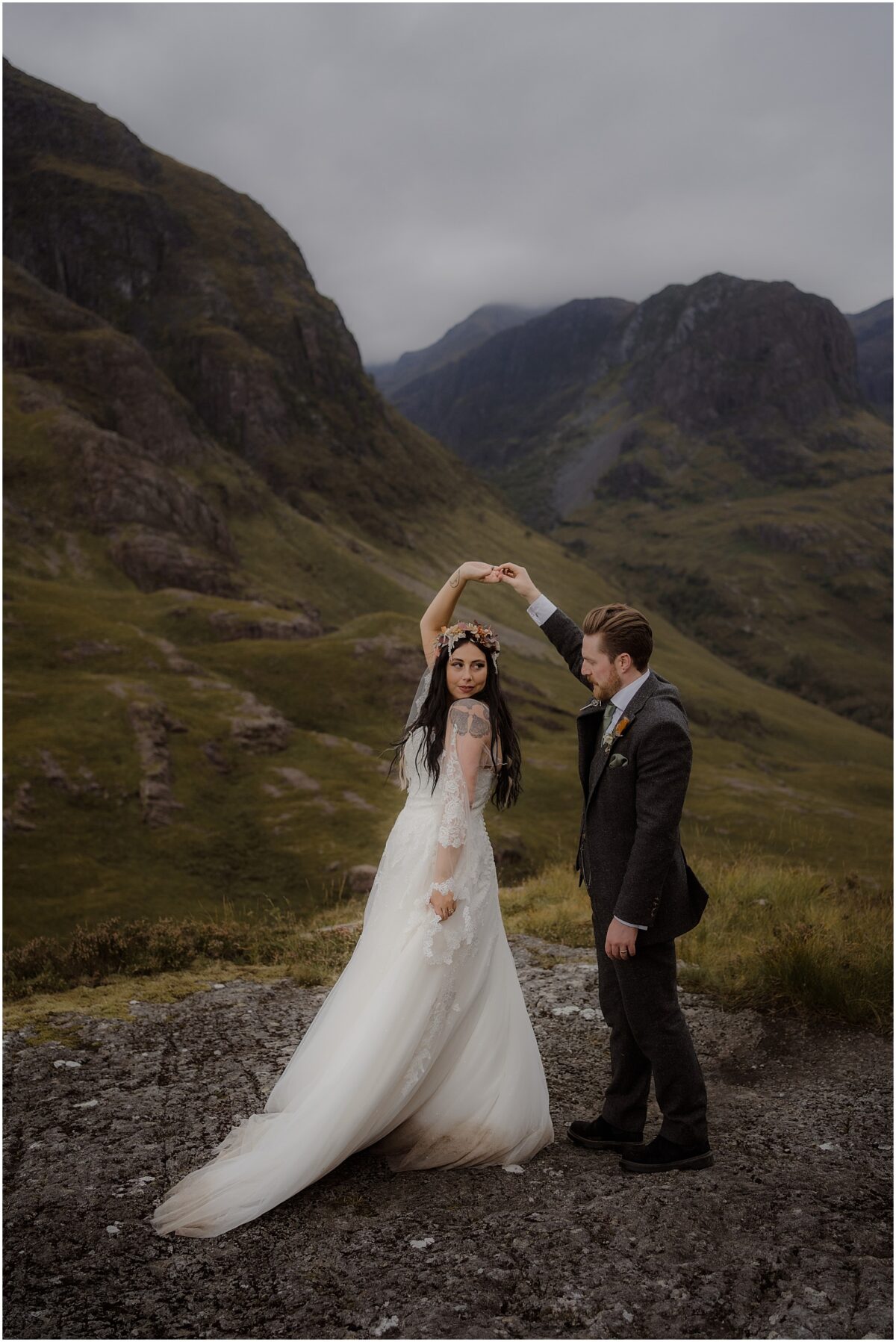 Glencoe wedding photos - Glencoe wedding photographer Bride twirls satin dress during a dance with the groom, mountain backdrop behind them