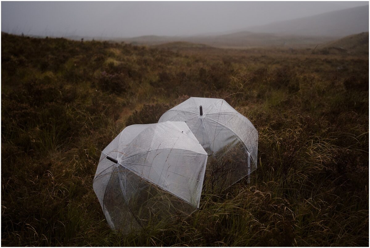 Wedding photoshoot in Glencoe - Glencoe wedding photographer Clear umbrellas marked with raindrops at Rannoch Moor