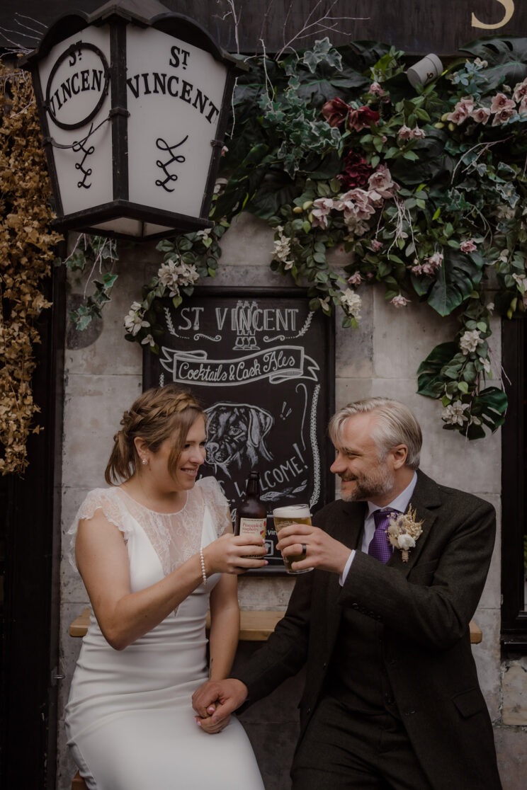 Couple having a celebratory drink after getting married in Edinburgh - Scotland photo ideas