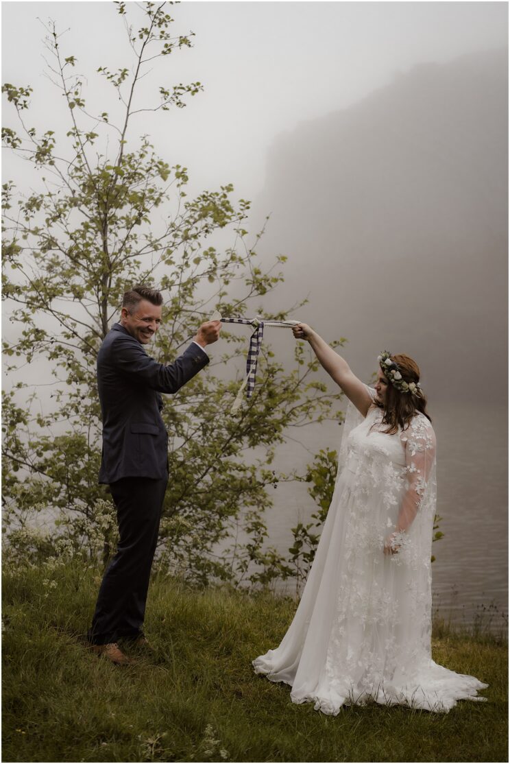 Misty outdoor wedding ceremony at Dunsapie Loch in Edinburgh, Scotland