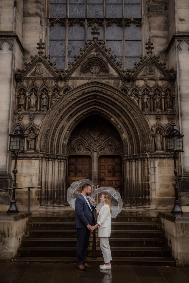 Couple photoshoot with umbrellas in the rain - elopement photography Edinburgh