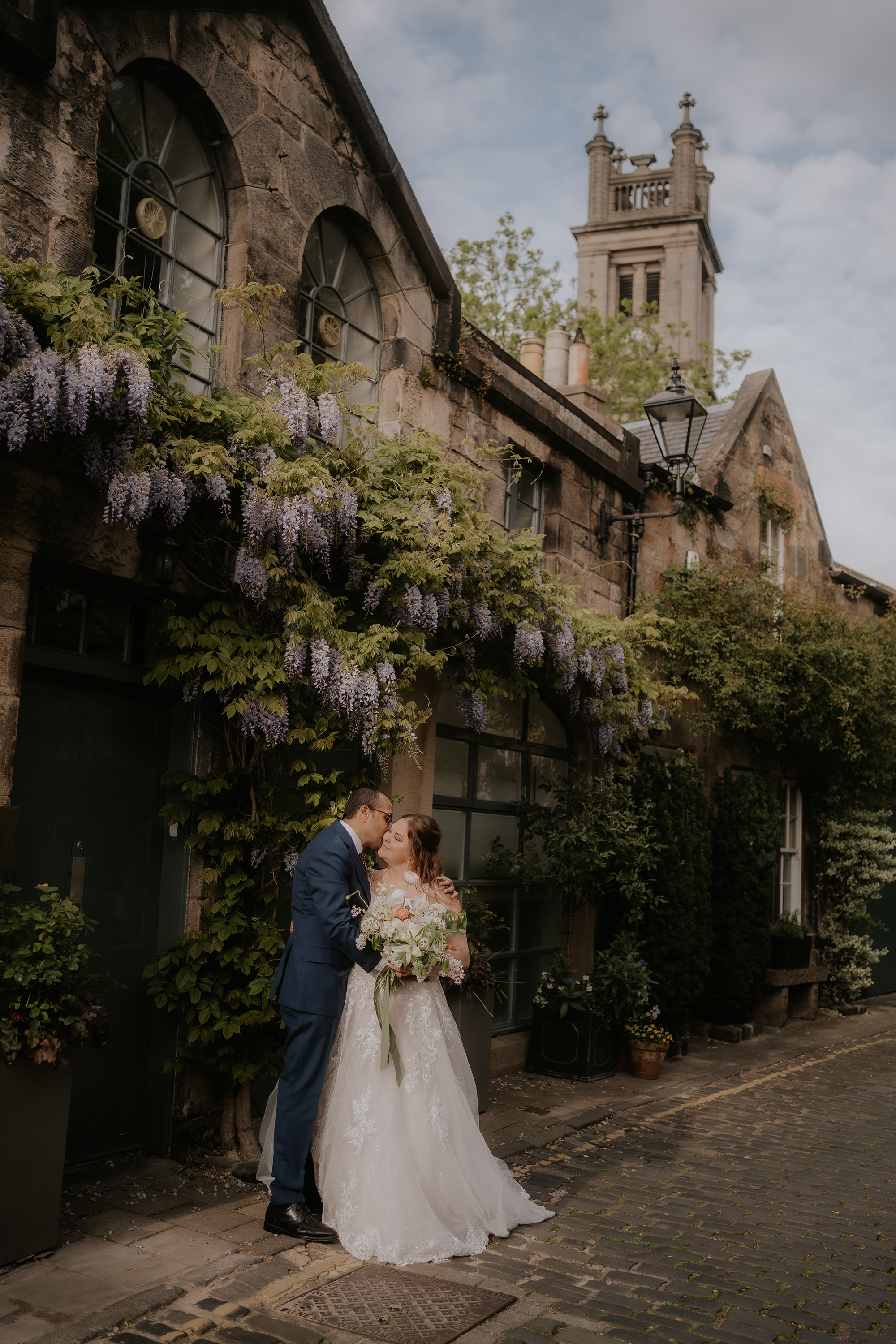 Wedding photos under wisteria arched in spring in Edinburgh