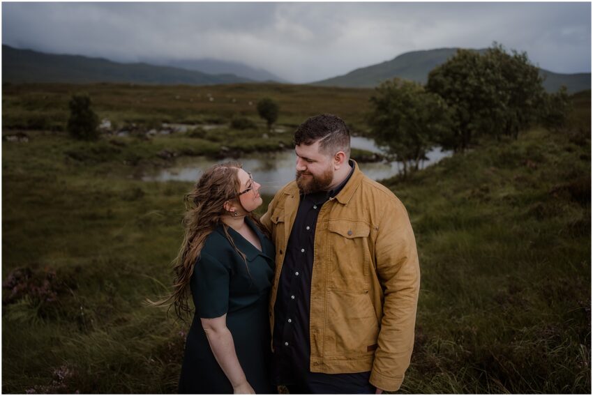 Couple posing near a lake in Glencoe