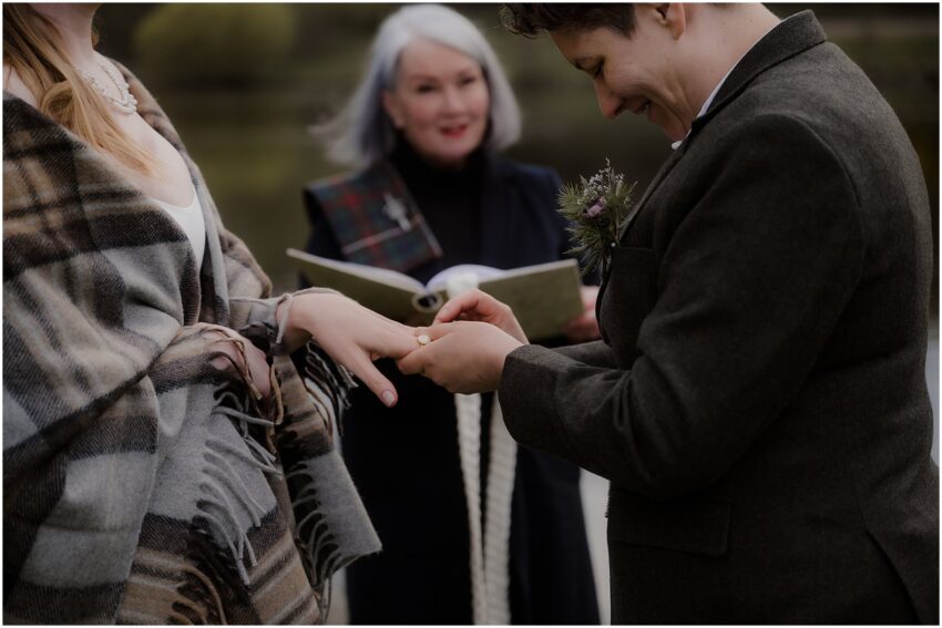 Two brides exchanging rings at their wedding ceremony in Edinburgh - LGBT elopement wedding in Scotland