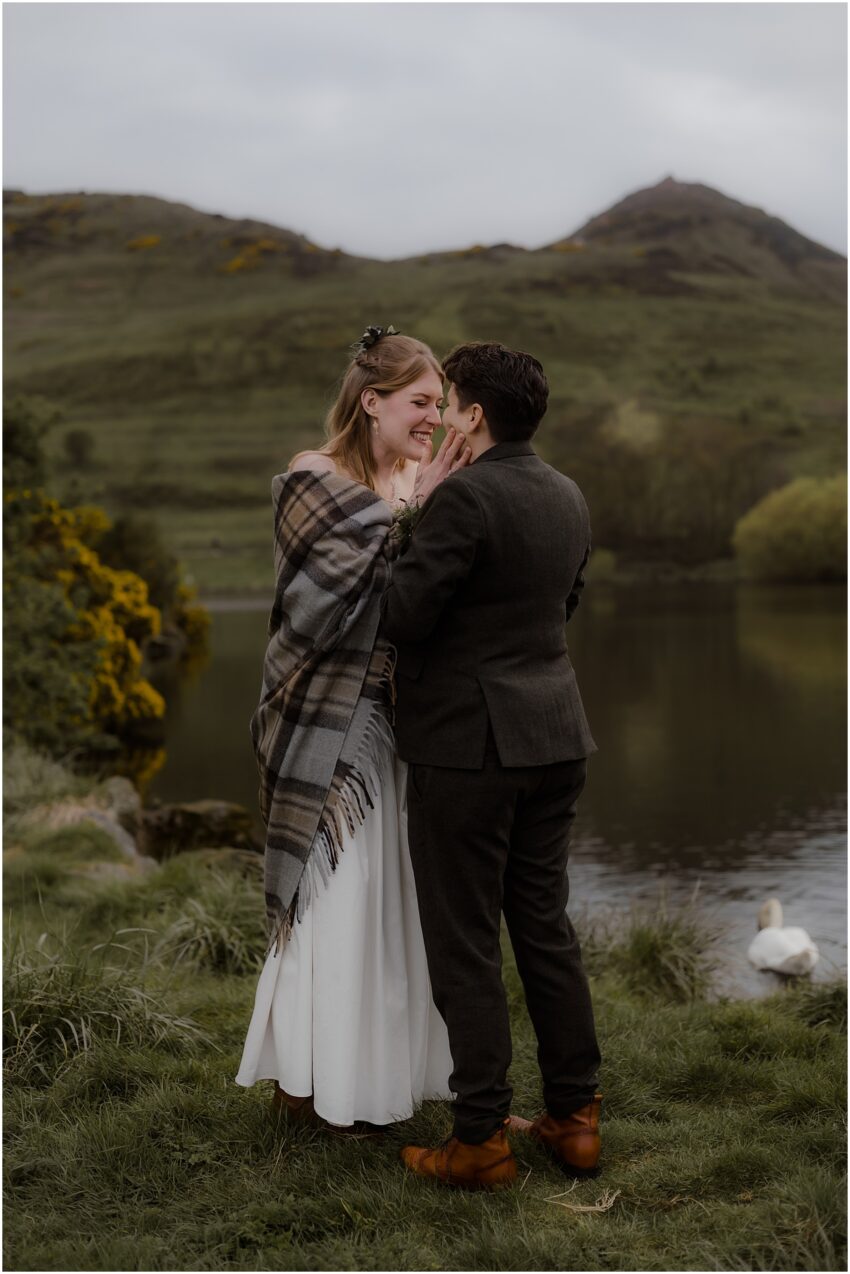 Two brides kissing at their wedding ceremony in Edinburgh - LGBT elopement wedding in Scotland