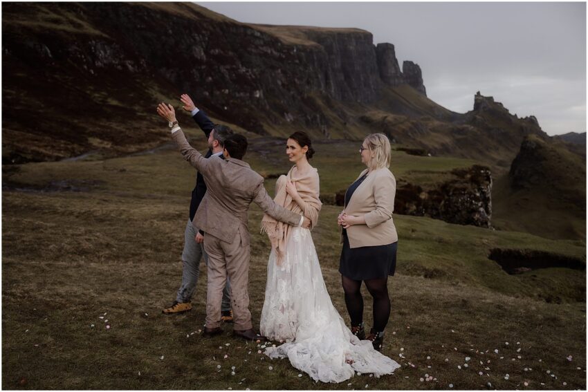 Groom and witness waving at hill walkers in Quiraing on Skye