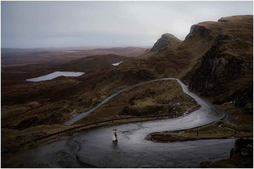 Bride and groom kissing on the Quiraing road during their wedding photoshoot