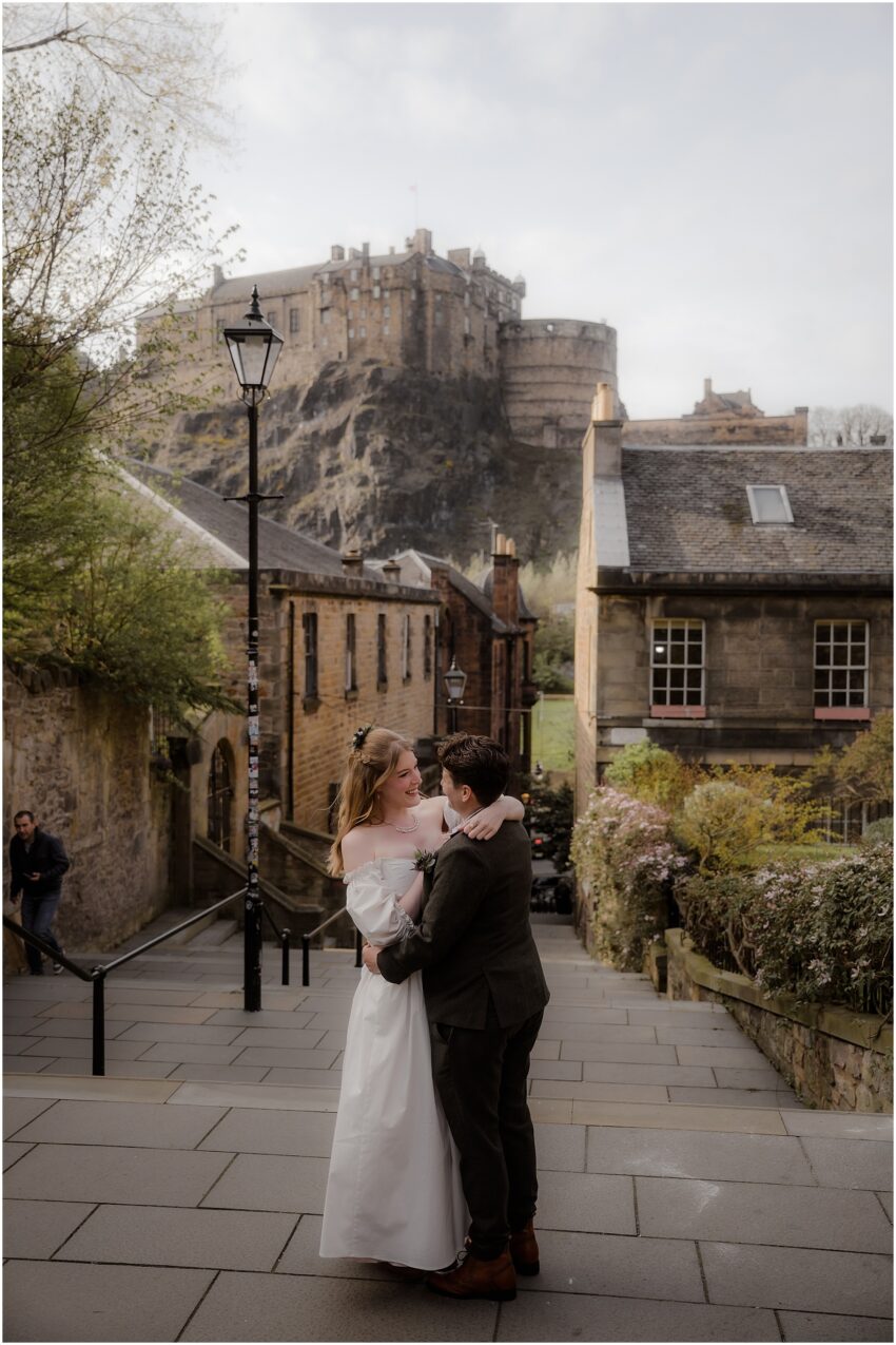 Same-sex wedding photos in Edinburgh Old town with Edinburgh Castle in the background