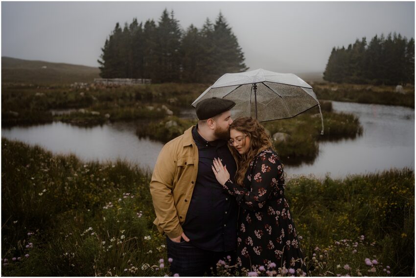 Couple under an umbrella on a rainy day in Scotland