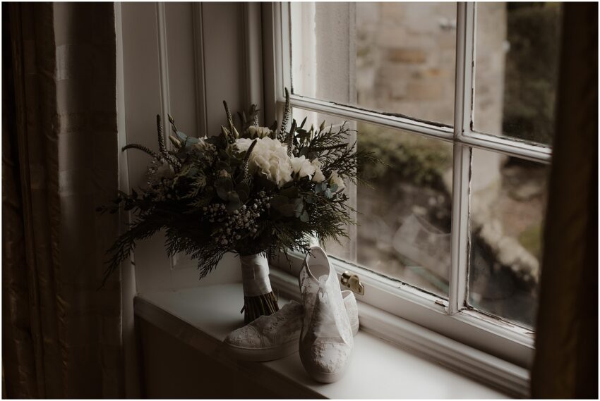 Flower bouquet next to a window at the wedding venue