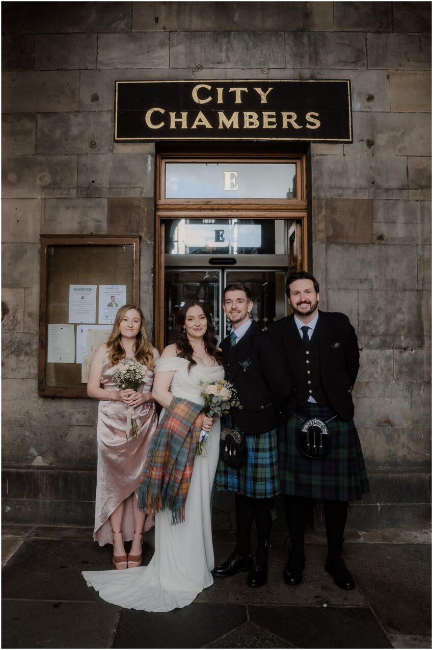 Edinburgh City Chambers wedding - bride and groom and their wedding guests in front of the City Chambers Edinburgh entrance