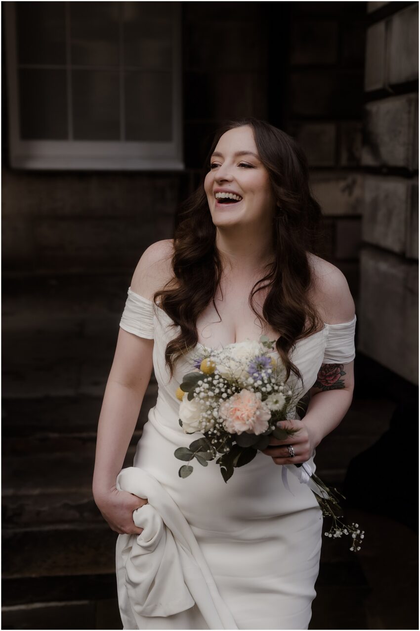 Happy bride after the wedding ceremony - walking and smiling on Royal Mile