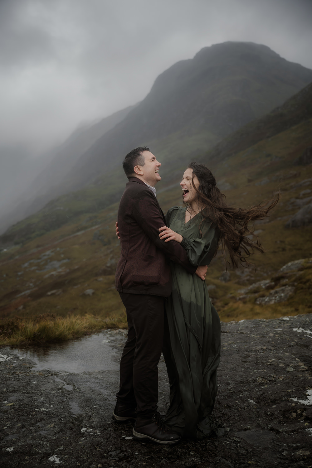 Advice for Rainy Wedding Days in Scotland - turn rain into romance 3 Bride and groom cuddling and laughing uncontrollably in the downpour on their rainy wedding day in the highlands