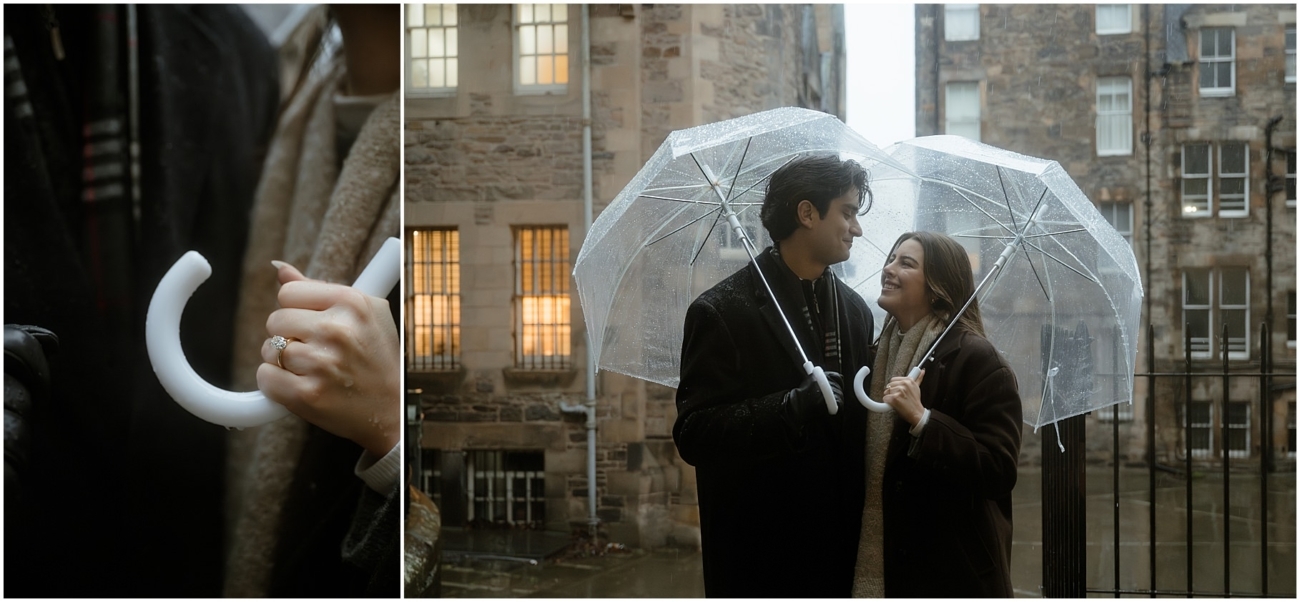 The couple stands closely together under a clear umbrella, smiling warmly at each other, with Edinburgh’s Old Town buildings softly illuminated in the background