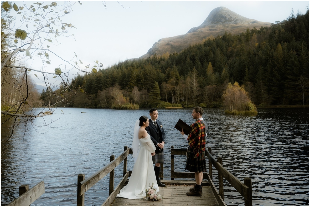 Scottish lochside wedding ceremony with a humanist celebrant in a tartan kilt on a wooden jetty