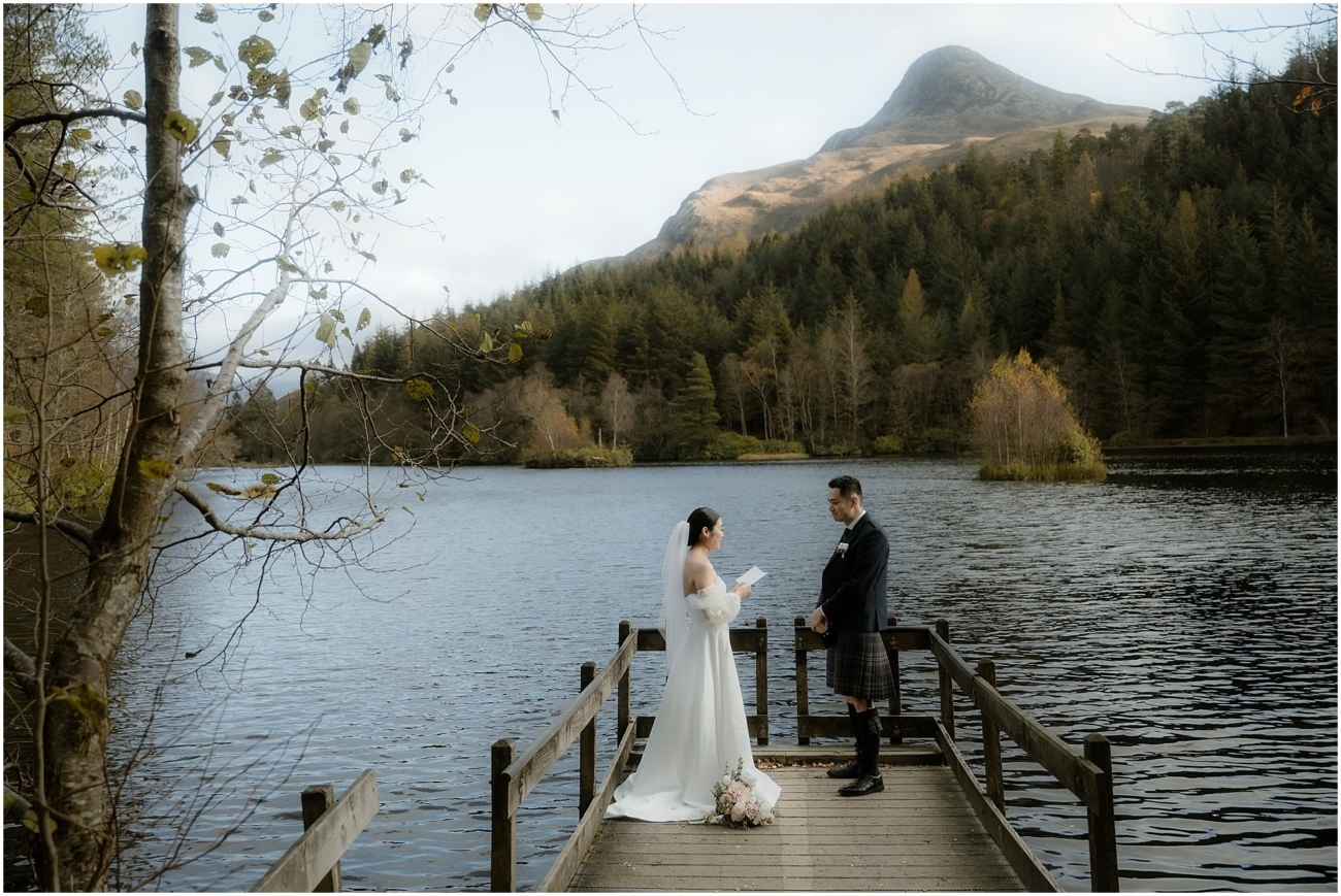 Bride reading her personal vows to the groom on the Glencoe Lochan jetty