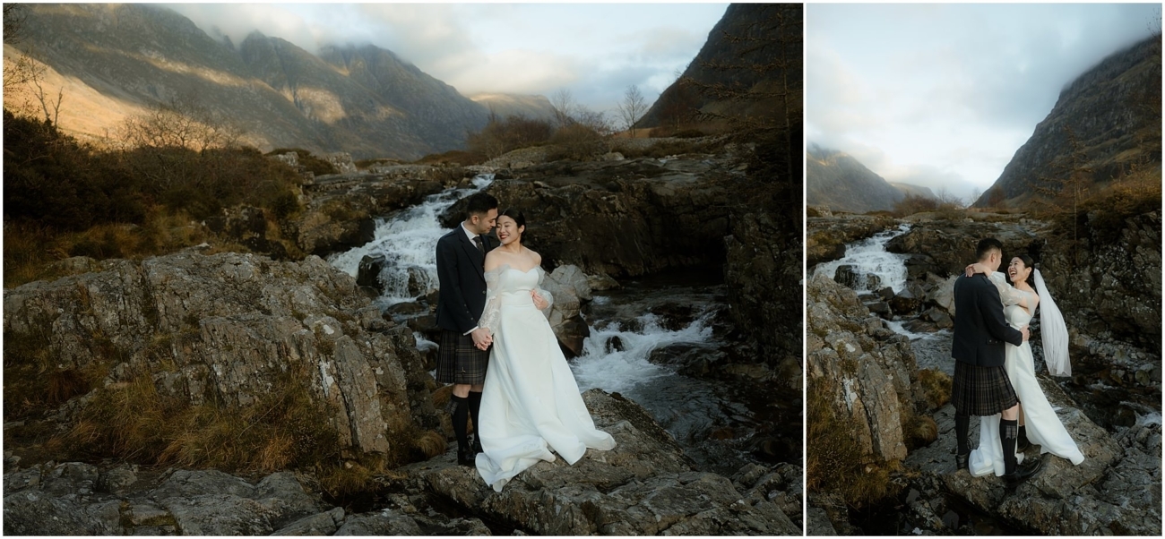 Newlyweds embracing in front of a rocky waterfall