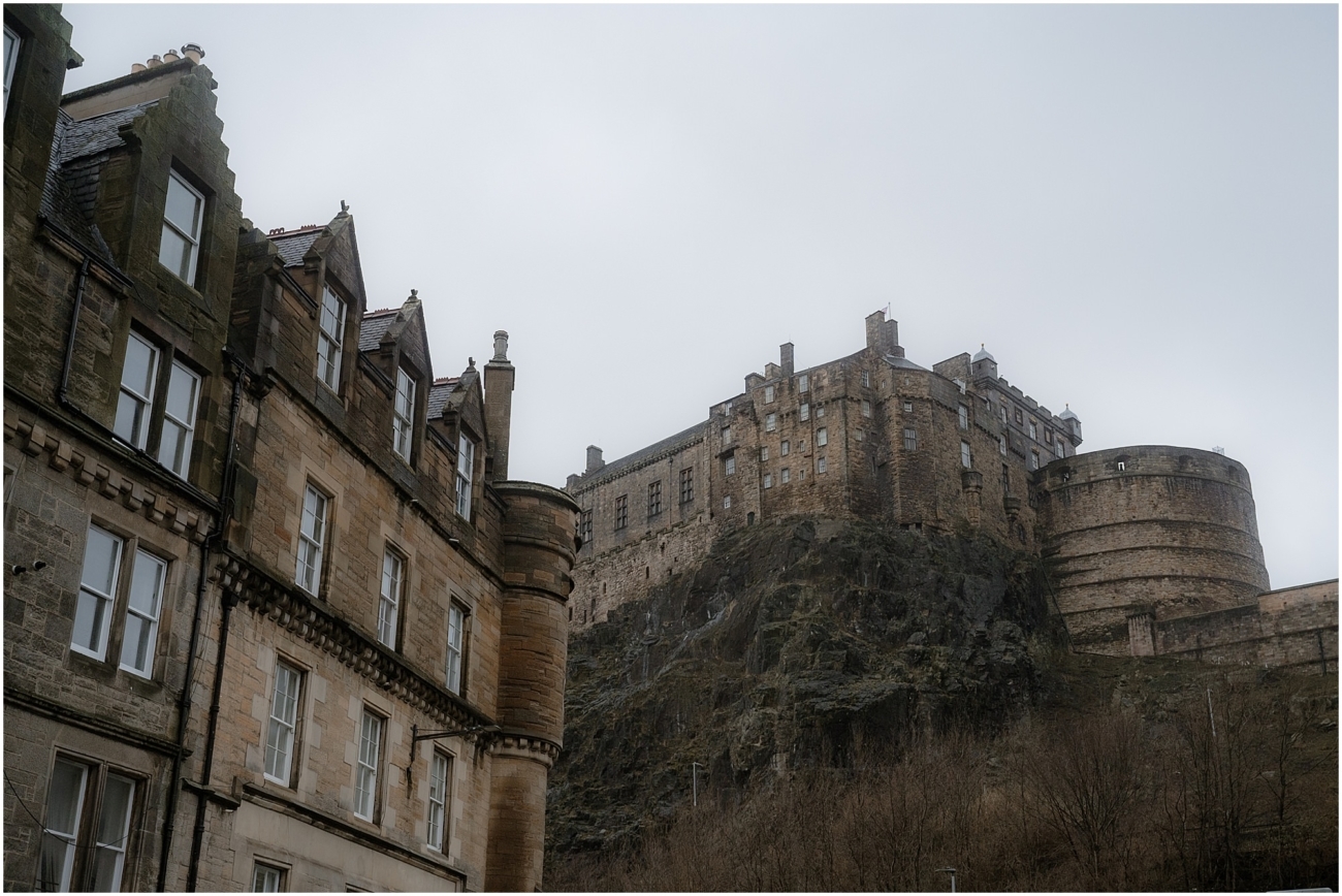 Moody winter view of Edinburgh Castle rising above the city’s old stone buildings, shrouded in mist, captured from the Grassmarket area.