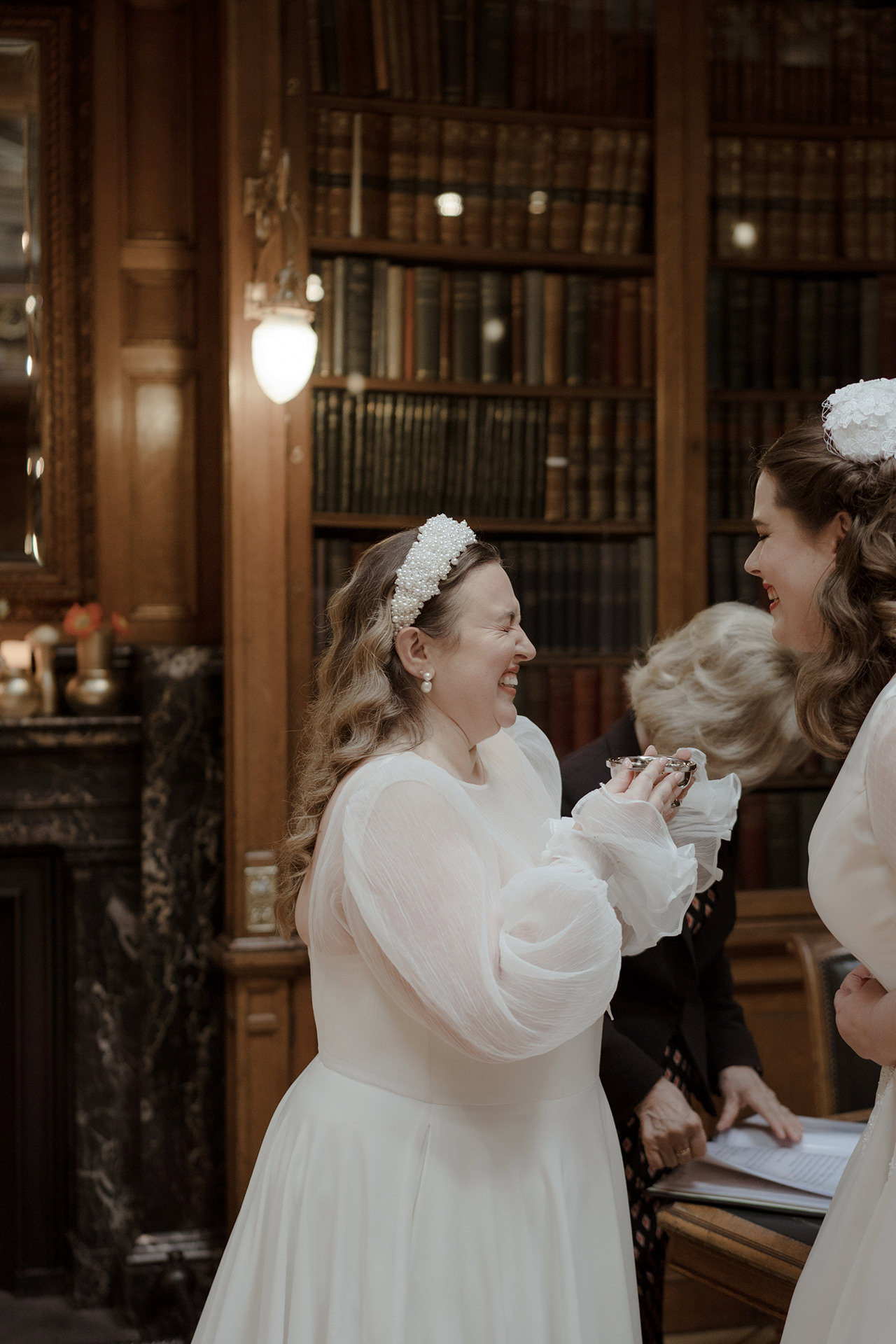 Brides sharing a laugh during the quaich ceremony at the New Library at RCP in Edinburgh