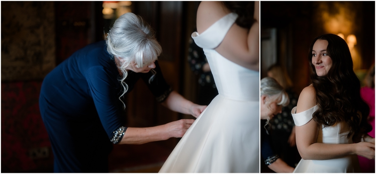 Mother helping bride into her wedding dress inside The Witchery’s richly decorated room, full of antique wood and warm light.