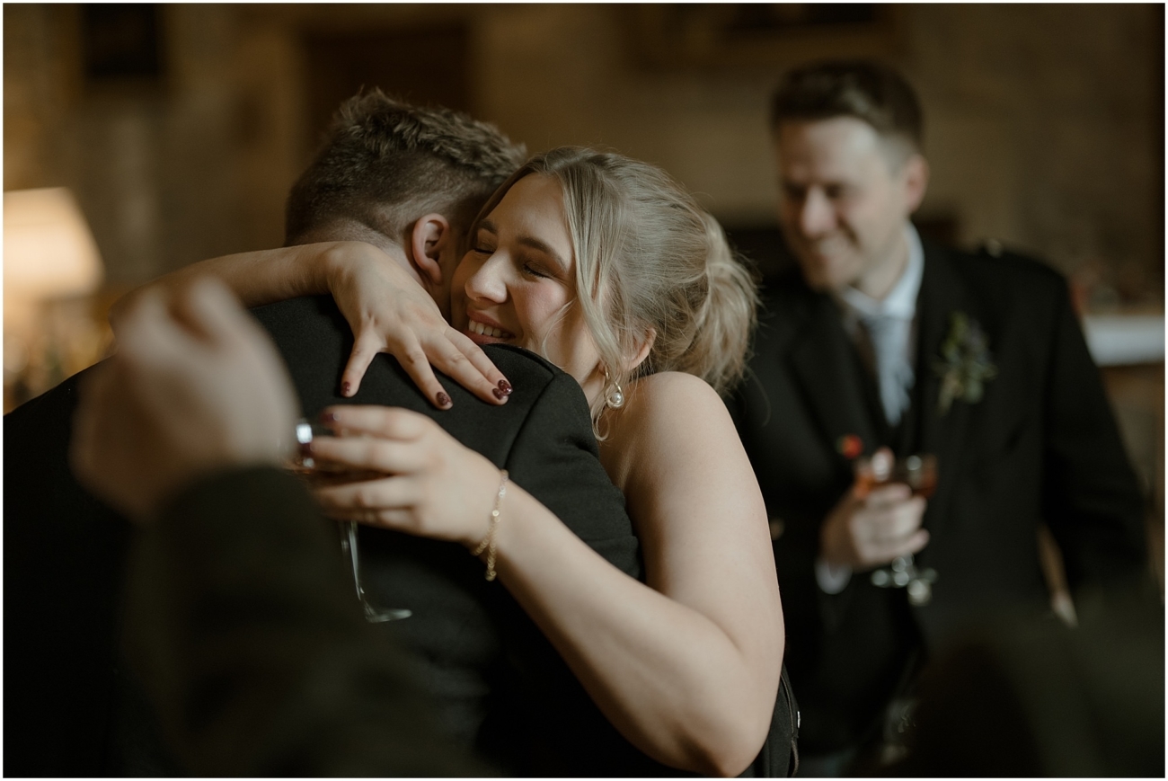 Cosy & Intimate Wedding at Ferniehirst Castle in the Scottish Borders 13 Guest hugging the couple after the ceremony