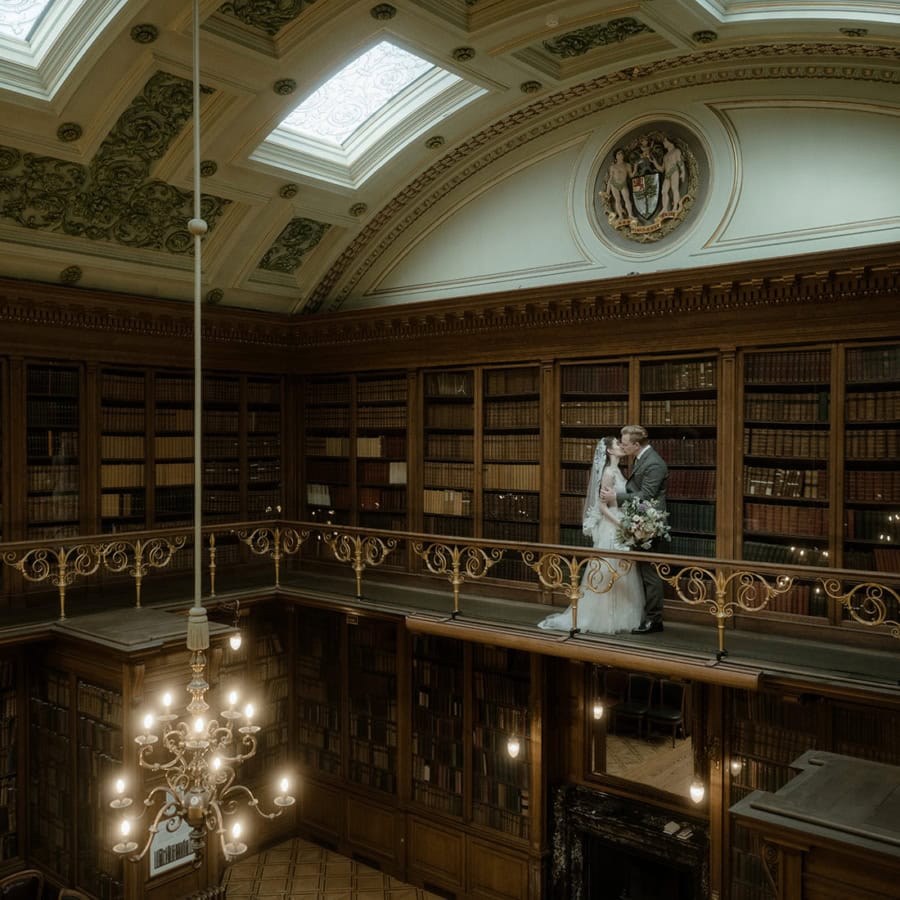 Couple kissing on the gallery level of the New Library at the Royal College of Physicians Edinburgh