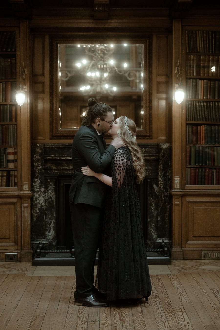 Weddings at the Royal College of Physicians Edinburgh: everything you need to know 14 Couple sharing their first kiss in front of the Georgian fireplace in the New Library