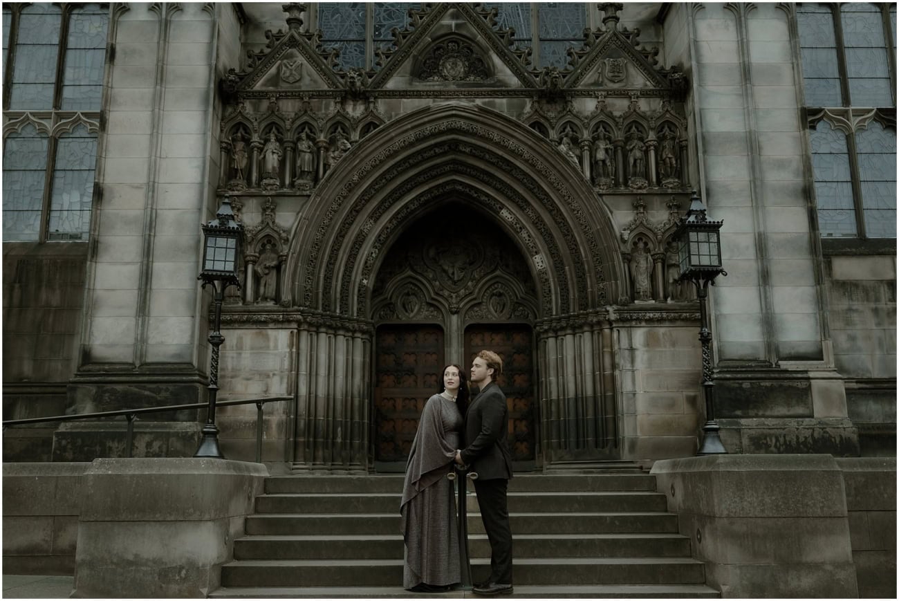 Couple standing together in front of the grand gothic entrance of St Giles Cathedral Edinburgh