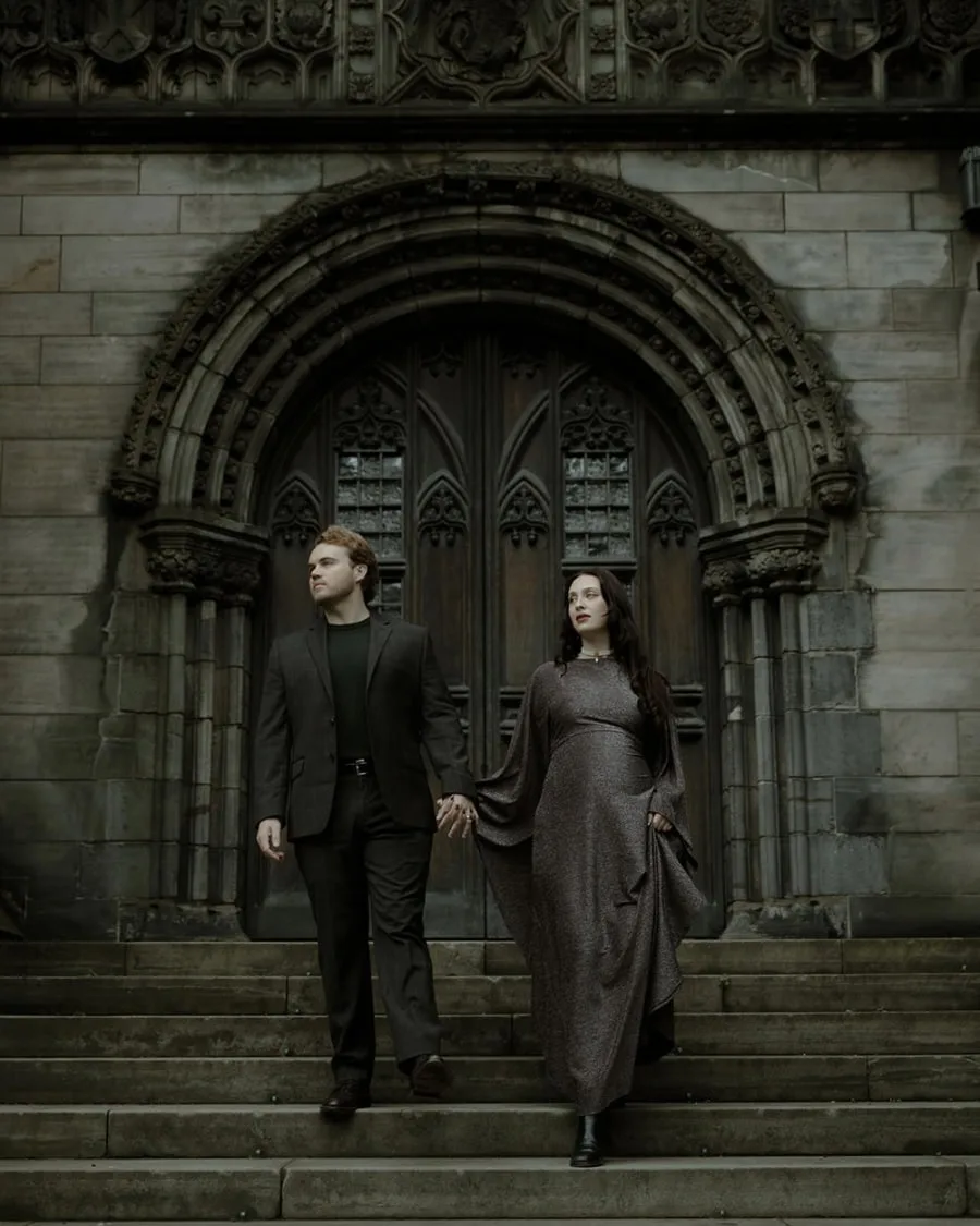Bride and groom dressed in dark academia style aesthetic, walk down the steps of St Giles Cathedral in Edinburgh - gothic couple photo session Scotland